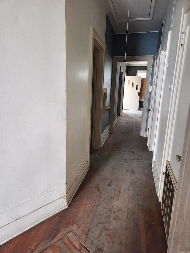 corridor featuring dark hardwood / wood-style floors