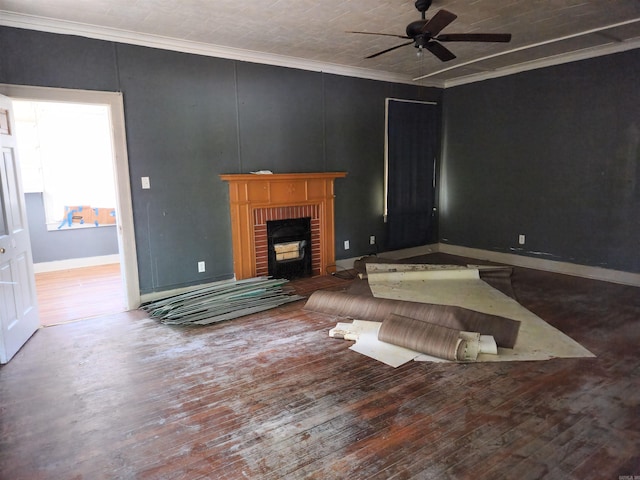 living room featuring crown molding, hardwood / wood-style floors, ceiling fan, and a brick fireplace