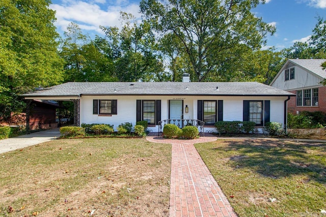 ranch-style home featuring a porch, a front lawn, and a carport