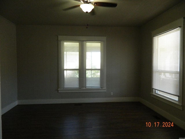 empty room with dark hardwood / wood-style floors and ceiling fan