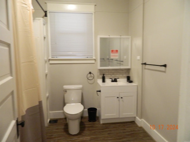 bathroom with vanity, toilet, decorative backsplash, and hardwood / wood-style floors