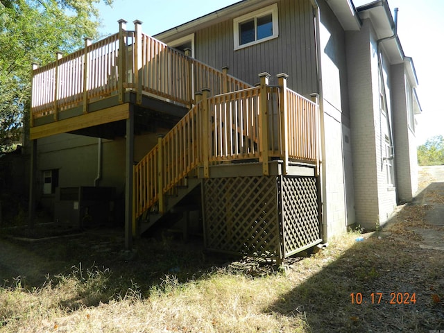 back of house with a deck