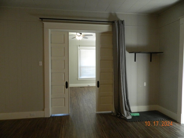 interior space with ornamental molding, dark hardwood / wood-style floors, and ceiling fan