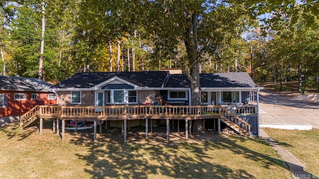 back of house featuring a yard and a deck