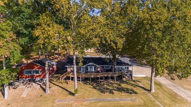 back of property featuring a deck and a yard