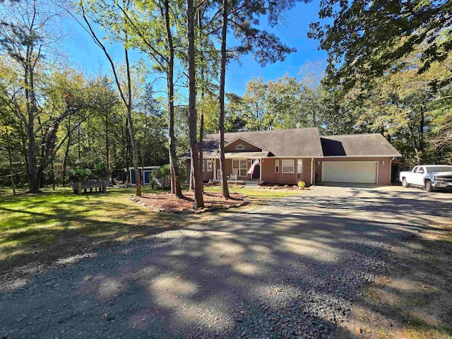 ranch-style home featuring a front lawn and a garage