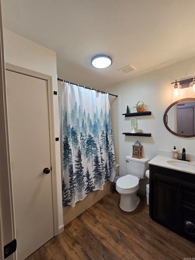 full bathroom with toilet, shower / bath combo, hardwood / wood-style flooring, and vanity