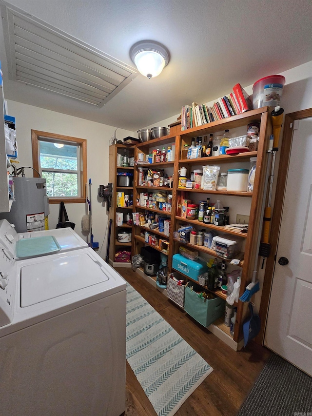 laundry room featuring washer and dryer, gas water heater, and dark hardwood / wood-style floors