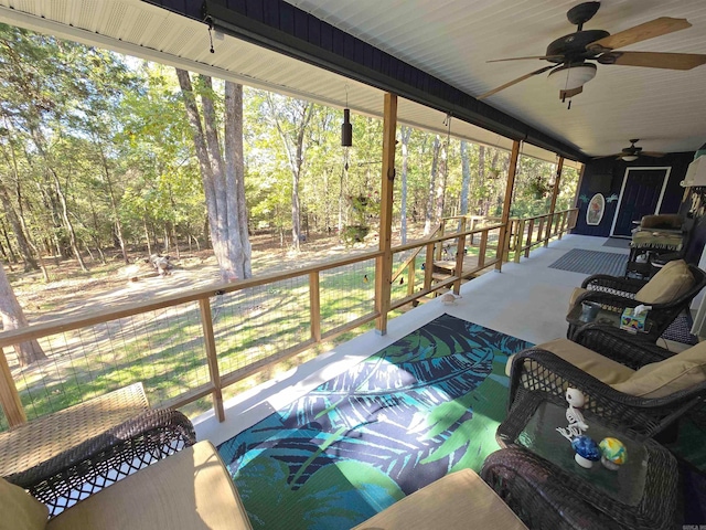 sunroom / solarium with a wealth of natural light and ceiling fan