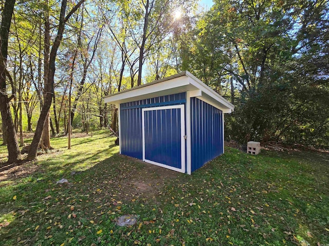 view of outbuilding with a lawn