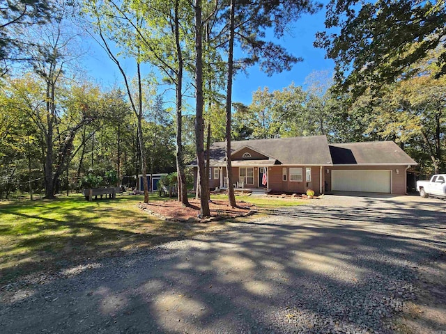 ranch-style house with a front yard and a garage