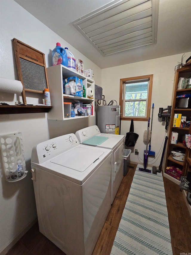 clothes washing area with electric water heater, washer and clothes dryer, and dark hardwood / wood-style floors