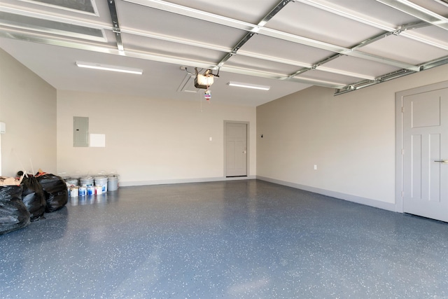 garage with a garage door opener and electric panel