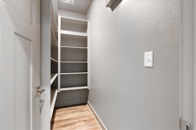 walk in closet featuring light hardwood / wood-style floors