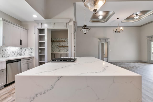 kitchen featuring light hardwood / wood-style floors, stainless steel appliances, a center island, and pendant lighting