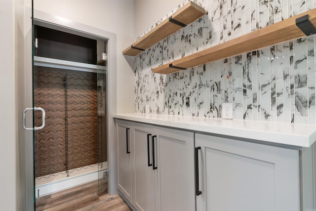 interior space featuring wood-type flooring and walk in shower