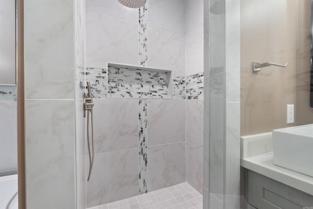 bathroom with vanity and tiled shower