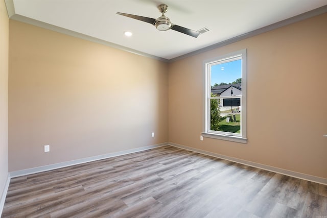 empty room with ornamental molding, light hardwood / wood-style floors, and ceiling fan