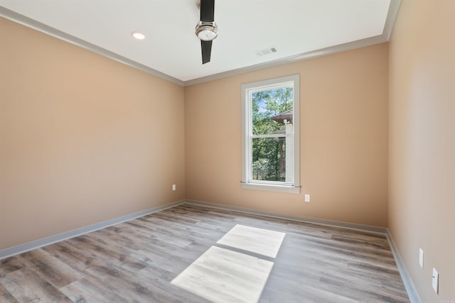 spare room with light hardwood / wood-style flooring, crown molding, and ceiling fan