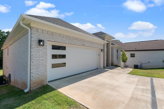 ranch-style house featuring a front yard and a garage