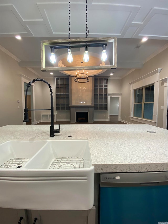 kitchen with stainless steel dishwasher, ornamental molding, sink, and a chandelier