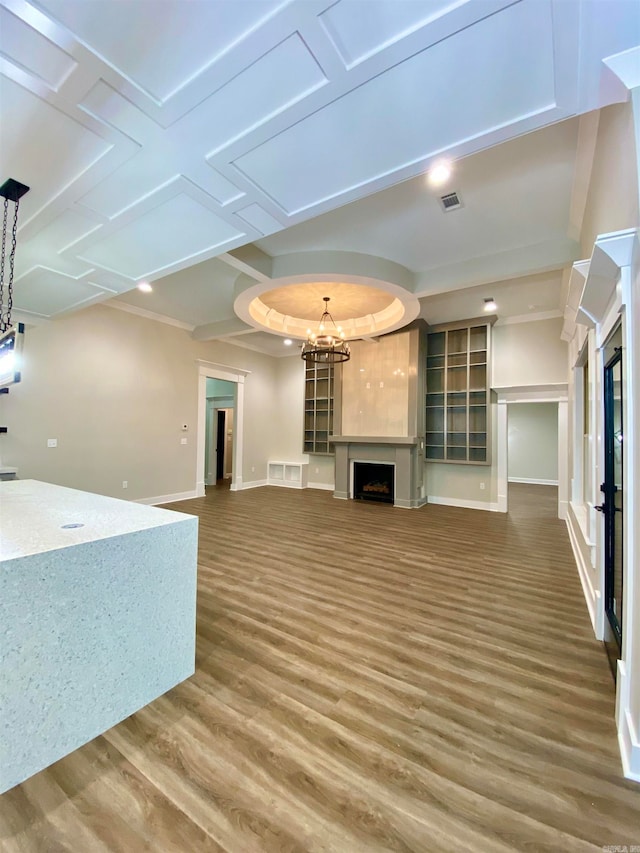 unfurnished living room featuring hardwood / wood-style floors and a chandelier