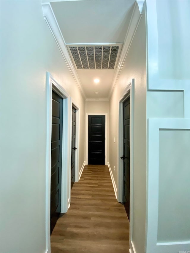 hall with crown molding and hardwood / wood-style flooring