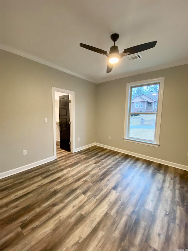 spare room with ceiling fan, ornamental molding, and dark hardwood / wood-style floors