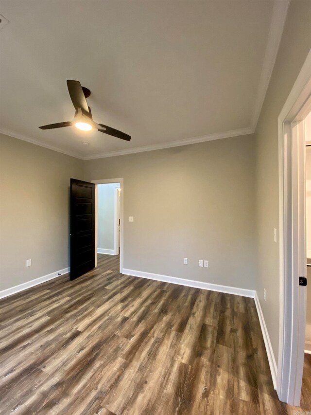 spare room featuring ornamental molding, ceiling fan, and dark hardwood / wood-style flooring