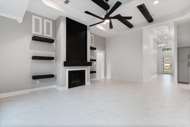 unfurnished living room featuring ceiling fan, beam ceiling, and a large fireplace