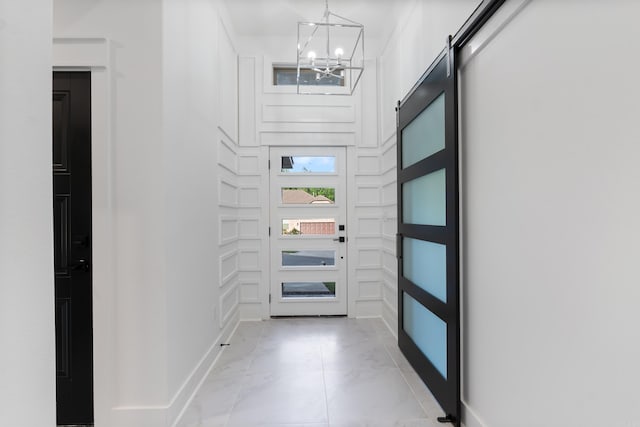 entryway with a notable chandelier and a barn door