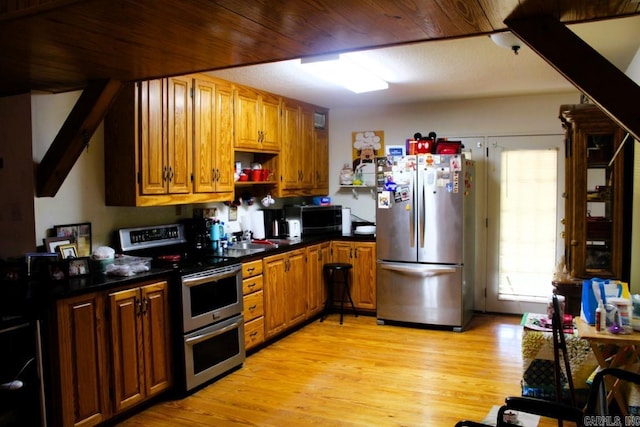 kitchen featuring sink, appliances with stainless steel finishes, and light hardwood / wood-style flooring