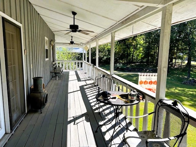 wooden deck featuring a yard and ceiling fan