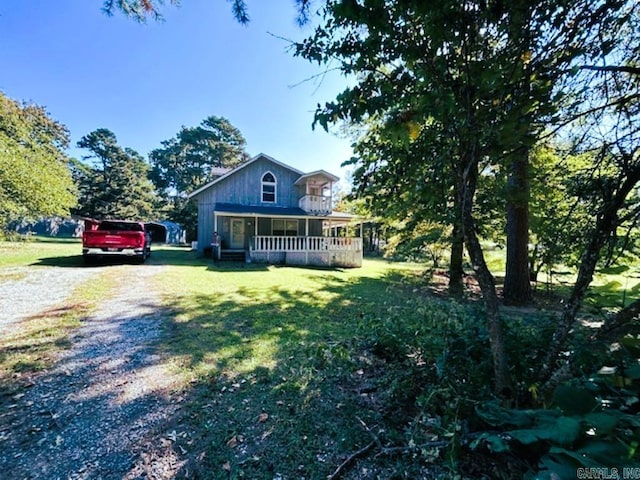 view of front of house with a porch and a front lawn