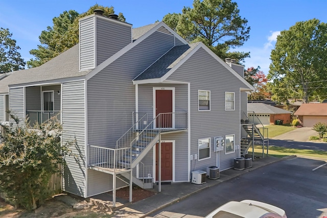 view of front of property with central AC and a garage