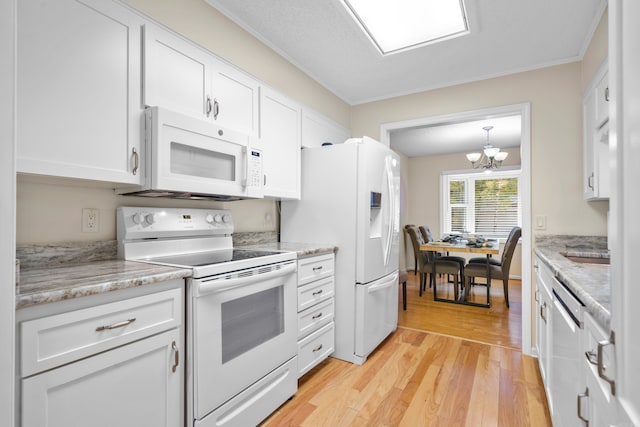 kitchen featuring ornamental molding, white cabinets, light hardwood / wood-style flooring, and white appliances