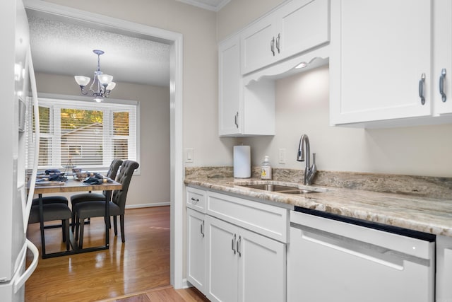 kitchen with white cabinets, a textured ceiling, light hardwood / wood-style floors, sink, and white appliances