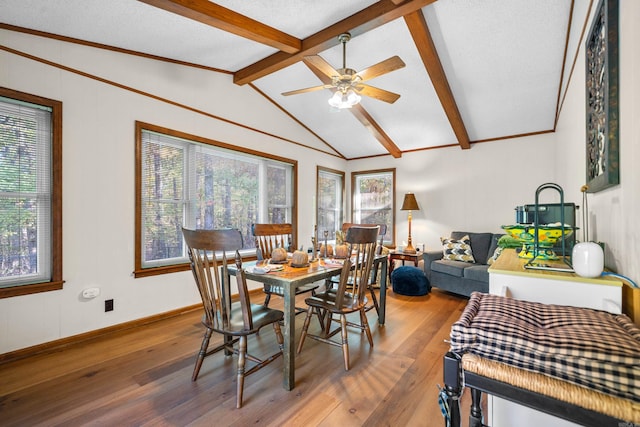 dining area with vaulted ceiling with beams, a textured ceiling, wood-type flooring, and ceiling fan