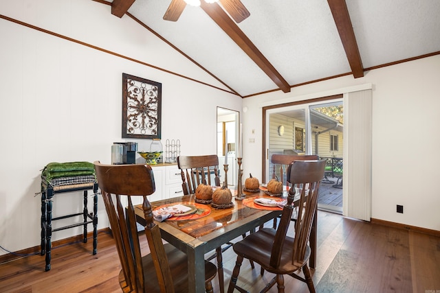 dining area with hardwood / wood-style floors, vaulted ceiling with beams, and ceiling fan