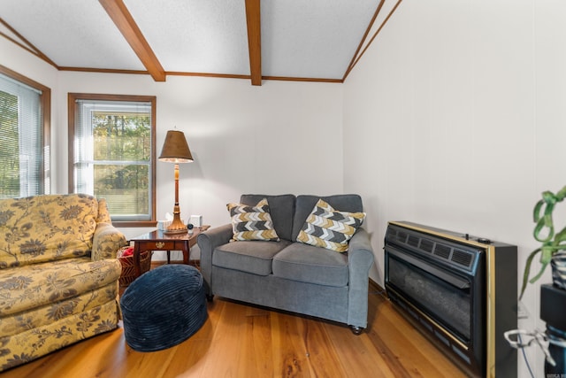 living room with crown molding, lofted ceiling with beams, wood-type flooring, and heating unit