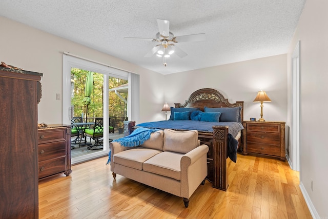 bedroom featuring access to outside, a textured ceiling, light wood-type flooring, and ceiling fan