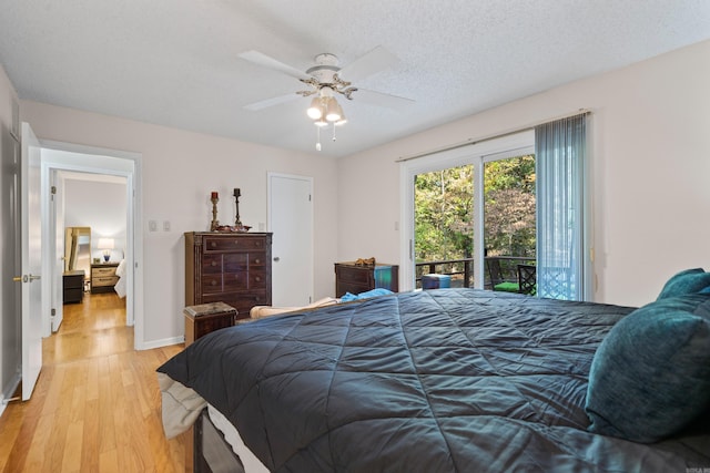 bedroom with light hardwood / wood-style floors, a textured ceiling, access to exterior, and ceiling fan