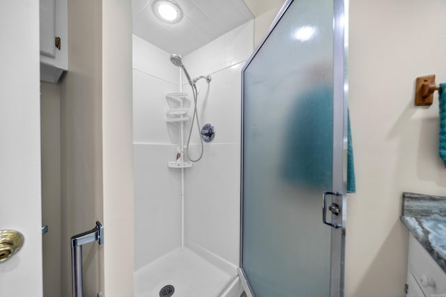 bathroom with vanity and a shower with shower door