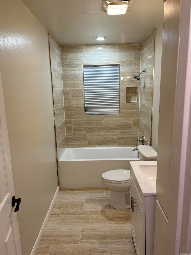 full bathroom with toilet, tiled shower / bath combo, and vanity