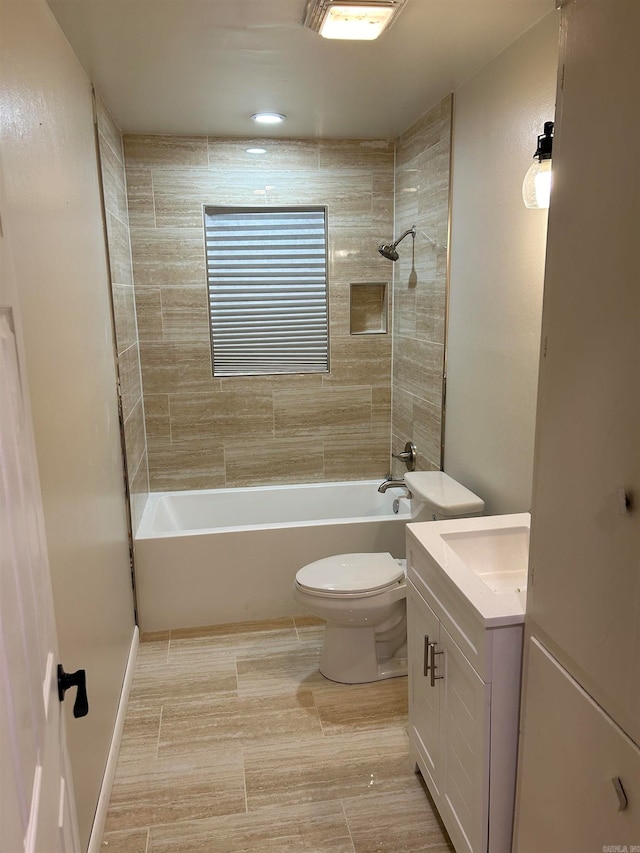 full bathroom featuring vanity, toilet, and tiled shower / bath combo