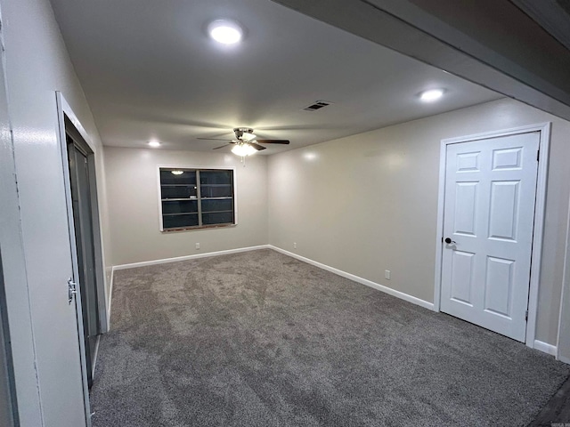 carpeted spare room featuring ceiling fan