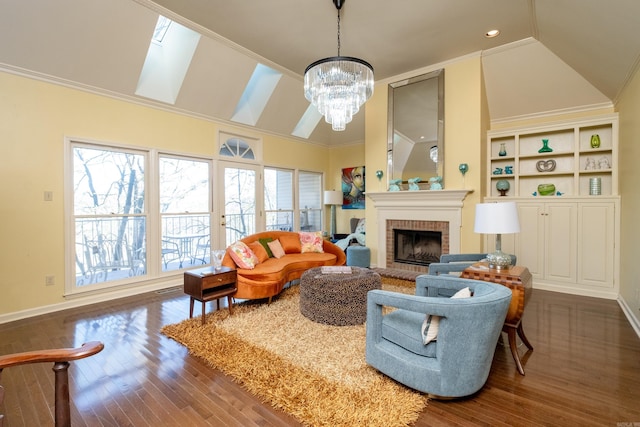 living room featuring dark hardwood / wood-style flooring, a brick fireplace, crown molding, a notable chandelier, and lofted ceiling with skylight