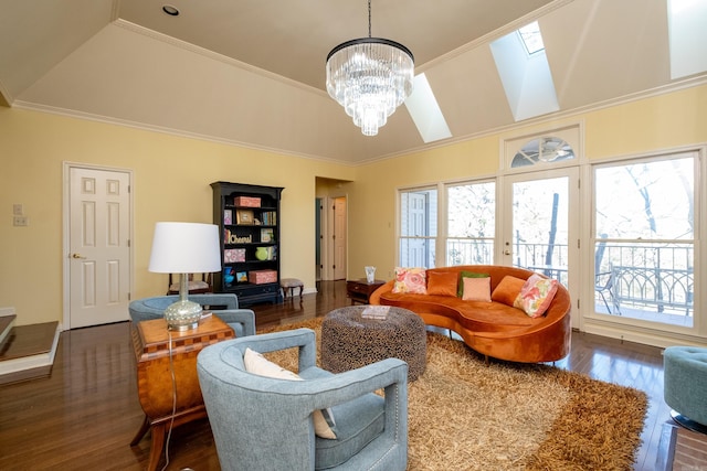 living room featuring a notable chandelier, dark hardwood / wood-style floors, a skylight, and crown molding