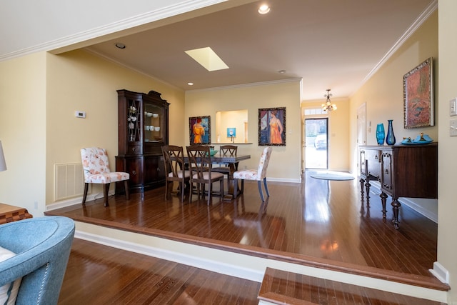 dining area featuring ornamental molding, a notable chandelier, dark hardwood / wood-style floors, and a skylight