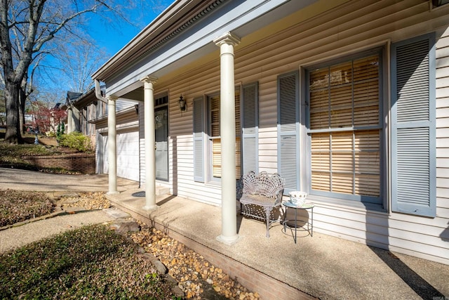 entrance to property with a porch and a garage